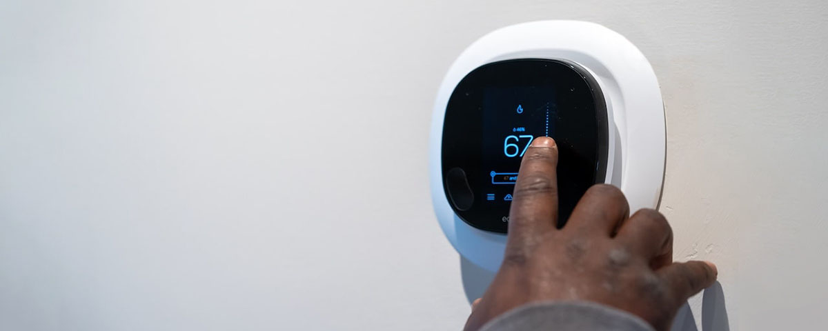 Get Ready for Winter With this HVAC Maintenance Checklist man adjusting thermostat